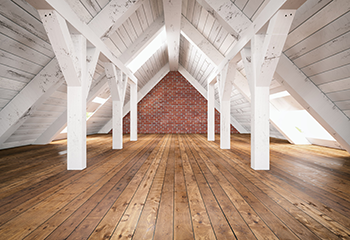 Dusty attic with old insulation before professional cleaning in Pearland.