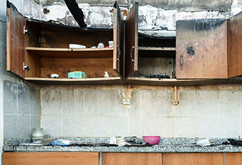 Fire-damaged home in South Houston showing soot-covered walls and structural damage.