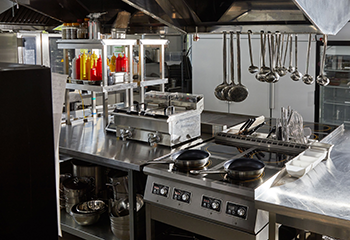 Commercial kitchen hood system before professional cleaning in West University Place restaurant.